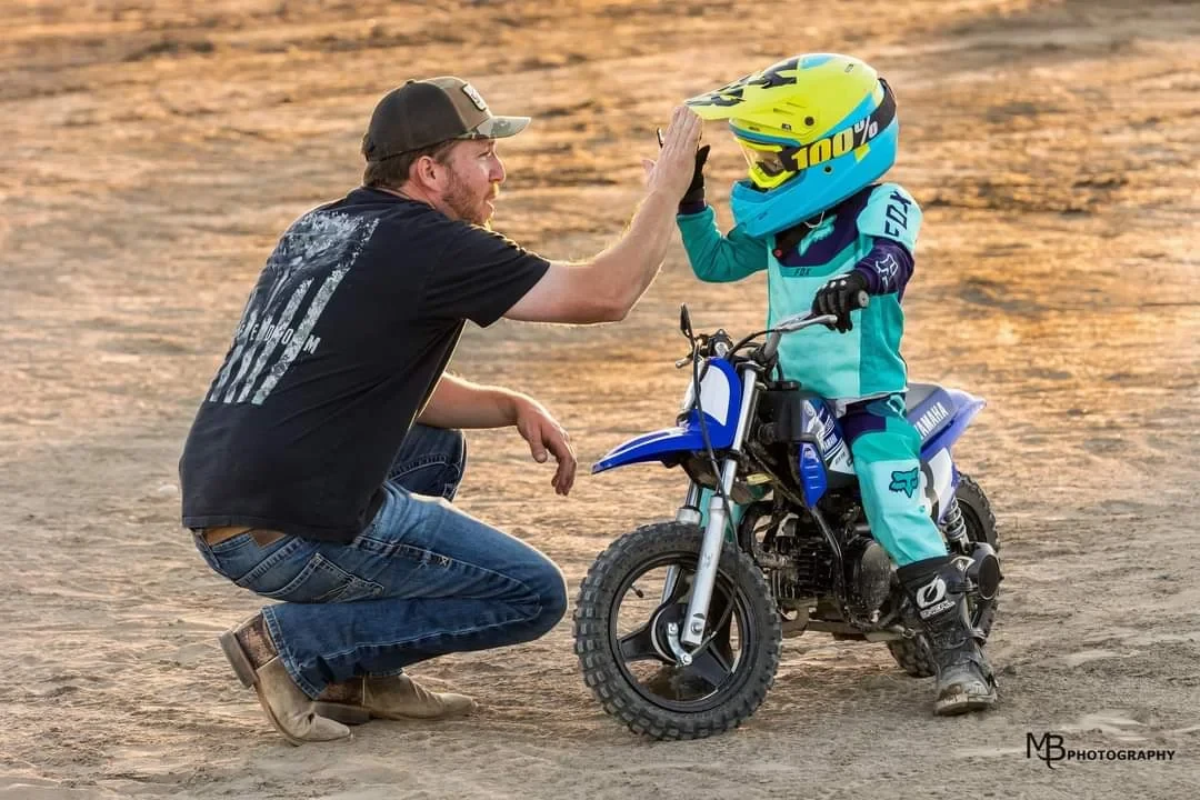 Dad giving high five to young motocross rider at HornrapidsMX